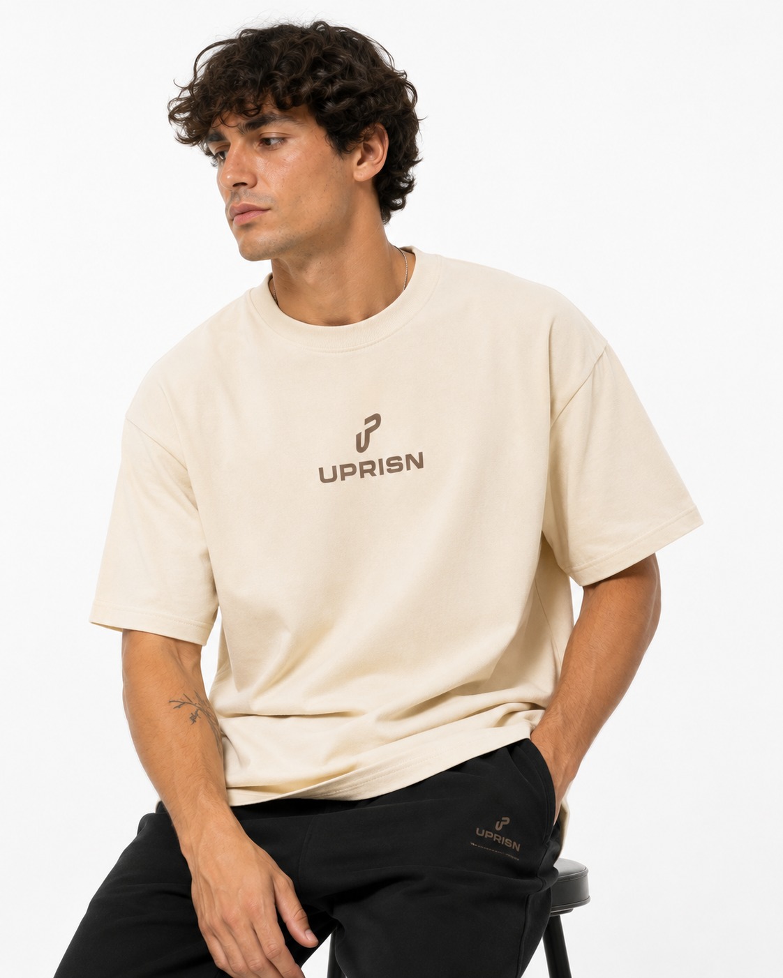 Model wearing UPRISN Christian tee in Cream, front